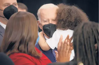  ?? SCOTT OLSON/GETTY ?? A boy whose father was one of 10 people killed in a mass shooting in Buffalo, N.Y., hugs President Joe Biden on Tuesday.