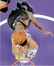  ?? AP ?? Ivica Zubac (below) of Los Angeles Lakers goes up for a dunk as JaKarr Sampson of Sacramento Kings defends during the first half of their NBA basketball game on Sunday in Los Angeles. King won 84-83. —