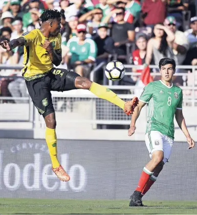  ??  ?? Jamaica’s Alvas Powell (left) controls the ball against Mexico’s Erick Gutierrez during the first half of their CONCACAF Gold Cup semi-final football match in Pasadena, California, on July 23, 2017.