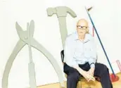  ?? KATE OWEN/THE NEW YORK TIMES ?? Claes Oldenburg sits in his New York studio with two of his sculptures. The Swedish-born American Pop artist died Monday at age 93.