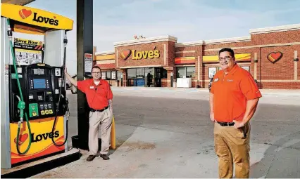  ?? [PHOTOS BY JIM BECKEL, THE OKLAHOMAN] ?? AT TOP: Love’s Travel Stops District Manager Dan West, right, and Operations Manager Chris Hendricks are seen at a Love’s in Guthrie along northbound Interstate 35.