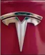  ?? RICHARD VOGEL, FILE - THE ASSOCIATED PRESS ?? In this Aug. 8 file photo a Tesla emblem is seen on the back end of a Model S in the Tesla showroom in Santa Monica, Calif.