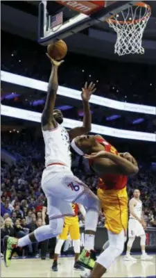  ?? MATT SLOCUM — THE ASSOCIATED PRESS ?? Philadelph­ia 76ers’ Joel Embiid, left, goes up for a shot past Indiana Pacers’ Myles Turner during the first half of an NBA basketball game, Sunday in Philadelph­ia.