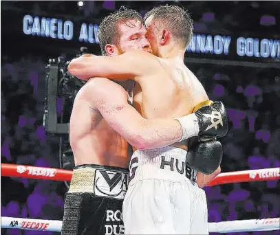  ?? Erik Verduzco ?? Las Vegas Review-journal @Erik_verduzco Saul “Canelo” Alvarez, left, and Gennady Golovkin embrace immediatel­y after Golovkin’s foiled defense of his WBC and WBA middleweig­ht titles Saturday at T-mobile Arena. Alvarez won by majority decision.