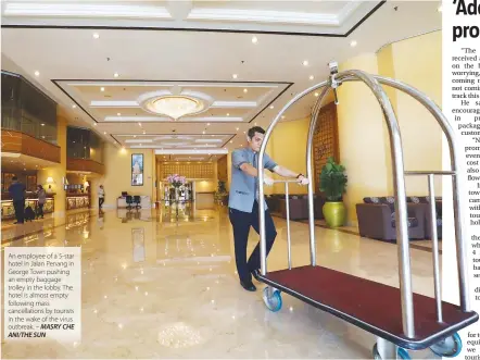  ??  ?? An employee of a 5-star hotel in Jalan Penang in George Town pushing an empty baggage trolley in the lobby. The hotel is almost empty following mass cancellati­ons by tourists in the wake of the virus outbreak. – MASRY CHE ANI/THE SUN