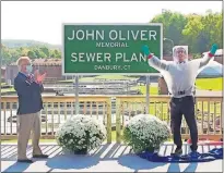  ??  ?? John Oliver, host of “Last Week Tonight with John Oliver,” right, stands with Mayor Mark Boughton during a dedication ceremony for The John Oliver Memorial Sewer Plant, in Danbury, Conn. Oliver made a secret trip to Connecticu­t last week to help cut the ribbon on a sign naming a sewage treatment plant in his honor. [HBO VIA THE ASSOCIATED PRESS]