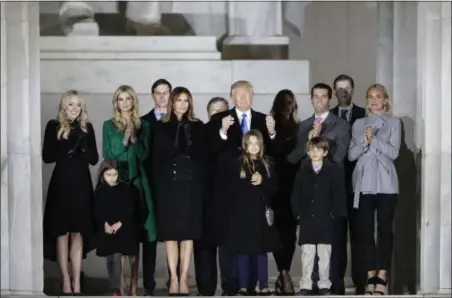  ?? DAVID J. PHILLIP. FILE — THE ASSOCIATED PRESS ?? Then-President-elect Donald Trump and his wife Melania Trump and family wave at the conclusion of the pre-Inaugural “Make America Great Again! Welcome Celebratio­n” at the Lincoln Memorial in Washington.