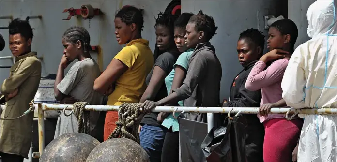  ??  ?? Lucky to be alive: Women plucked from the Mediterran­ean by an Italian navy vessel arrive at the port of Reggio Calabria in southern Italy yesterday