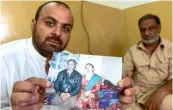  ?? — AP ?? Shehzada Khurram along with his father Imtiaz Javed holds a picture of his mother Shabana Shaheen who was killed by a stray bullet in 2015.