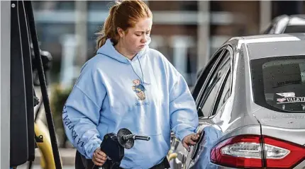  ?? JIM NOELKER/STAFF ?? University of Dayton student Megan Doyle pumps gas at the UDF at the corner of Brown and East Stewart streets, Wednesday, April 17, 2024. Per-gallon regular gas at both UDF and Speedway at the intersecti­on is $3.75 a gallon.