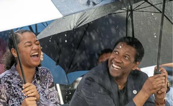  ?? Steph Chambers/Post-Gazette ?? A favorite photo: Jamaica Johnson, an 11th-grader at Pittsburgh CAPA, and actor Denzel Washington share a moment during a "groundbles­sing" at the August Wilson House on Sept. 26, 2018, in the Hill District.