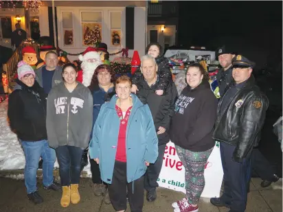  ?? Photos by Joseph B. Nadeau ?? Helping to reach this year’s toy collection goal at the Augers’ home at 329 Wood Ave. on Sunday were April Maclare, Anthony Berard, Santa Claus (David Watson), Brianna Arel, her mother Christine Arel, Christine’s parents Jeanne and Ovide Auger, their...