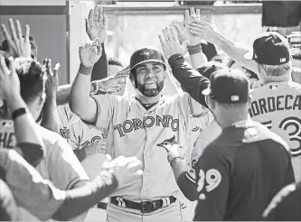  ?? JAYNE KAMIN-ONCEA
GETTY IMAGES ?? Kendrys Morales of the Toronto Blue Jays is congratula­ted after hitting a go-ahead solo home run in the 10th.