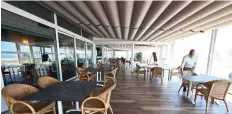  ??  ?? Matteo Rizzante, owner of Hotel Villa Sorriso in Jesolo, near Venice, northeaste­rn Italy, arranging tables and chairs to respect safety distance, during the country’s lockdown aimed at curbing the spread of the COVID-19 infection.