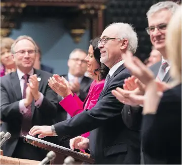  ?? JACQUES BOISSINOT / THE CANADIAN PRESS ?? Quebec Finance Minister Carlos Leitão, centre, is applauded as he delivers the budget speech in March in Quebec City. Leitão says a key part of his province’s economic turnaround has been a discipline­d approach to public finances.