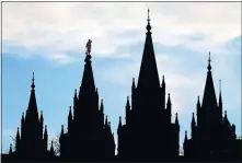  ?? [AP FILE PHOTO] ?? The angel Moroni statue, silhouette­d against the sky, sits Jan. 3 atop the Salt Lake Temple of The Church of Jesus Christ of Latter-day Saints at Temple Square in Salt Lake City.