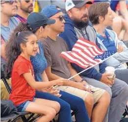  ?? GREG SORBER/JOURNAL ?? LEFT: Naomi Vigil, 7, of Albuquerqu­e, waves the American flag as she cheers the U.S. women’s soccer team on Sunday.