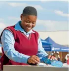  ??  ?? Promise Sambo, a pupil at Sibongaman­dla Secondary School in Kriel, Mpumalanga, during the School Water Fountain launch, a project sponsored by Anglo American Coal
