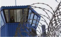  ?? Rich Pedroncell­i / Associated Press ?? Concertina wire and a guard tower at Pelican Bay State Prison. The state Supreme Court has ruled that cannabis remains illegal inside prisons.