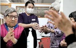 ?? KIN CHEUNG/AP ?? A nurse teaches elderly women how to sanitize their hands Friday at a nursing home in Hong Kong. Of the three virus deaths outside mainland China, one was in Hong Kong.