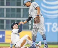  ?? Yi-Chin Lee / Houston Chronicle ?? Red Sox shortstop Xander Bogaerts, who feasted at the plate Sunday night, gives the Astros’ Alex Bregman a hand after forcing him out at second.