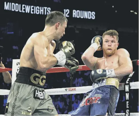  ?? PICTURE: JOHN GURZINSKI/AFP GETTY ?? 0 Canelo Alvarez, right, on the defensive during Saturday night’s Las Vegas bout with Gennady Golovkin.