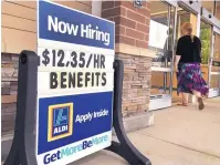  ?? ASSOCIATED PRESS FILE ?? A sign outside a business in Salem, N.H., advertises that it is looking for workers in this July photo. The Labor Department on Tuesday reported that hiring reached a record high.