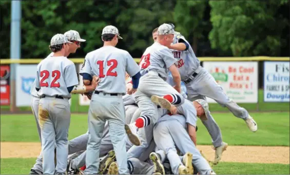  ?? THOMAS NASH — DIGITAL FIRST MEDIA ?? Members of the Spring City American Legion baseball team pile up behind the mound after claiming the Pa. State Tournament title on Wednesday.