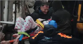  ?? (AP/Depo Photos) ?? People rescue a woman from the debris from Monday’s earthquake in Iskenderun, Turkey.