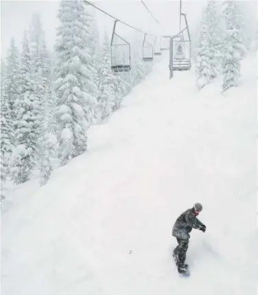  ??  ?? A snowboarde­r cruises down a slope at the Steamboat ski area in 2013.