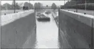  ?? ASSOCIATED PRESS PHOTO, FILE ?? In this Sept. 4, 1947file photo, an eastbound tanker, in foreground, prepares to pass a westbound one, background, after being released from a lock in the Erie Canal, in New York. Ground was broken for the Erie Canal 200years ago, and when the 363-mile...