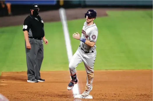  ?? David Zalubowski / Associated Press ?? Kyle Tucker puts the finishing touches on his big night by circling the bases after hitting a two-run home run off Rockies reliever James Pazos in the ninth inning. Tucker also had two triples among his four hits as the Astros set season highs for runs (13) and hits (20).