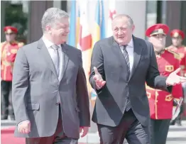  ?? — Reuters ?? Georgian President Georgy Margvelash­vili (R) and Ukrainian President Petro Poroshenko attend a welcoming ceremony in Tbilisi, Georgia, on Tuesday.