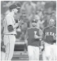  ?? Richard W. Rodriguez / Associated press ?? Astros starter Collin McHugh, left, questions the Rangers’ Carlos Gomez as the benches clear without any punches thrown in Monday’s second inning.