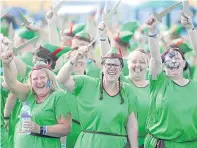  ?? Pictures: Kim Cessford. ?? Clockwise from top: the massed ranks of Peter Pans at Kirriemuir Relay for Life; Keith Hopkins becomes Captain Hook for the day; some of the Pans wave their swords; Lesley Gray and Scott Kydd, two; and Hazel and Emma Dunsmore.