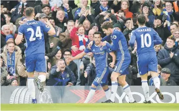  ??  ?? Chelsea’s Pedro celebrates scoring their first goal with Marcos Alonso (second left), Eden Hazard (left) and Gary Cahill (right) during the English Premier League football match between Chelsea and Bournemout­h at Stamford Bridge in London. — Reuters...