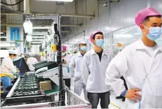 ?? AP ?? Workers at Foxconn factory in Wuhan. Of late, there have been many walkouts due to stringent Covid-19 measures.