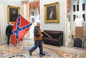  ?? SAUL LOEB AFP VIA GETTY IMAGES ?? Authoritie­s say Kevin Seefried of Delaware acknowledg­ed being the man photograph­ed with the Confederat­e flag in the Capitol Rotunda on Jan. 6 and turned himself in to police.