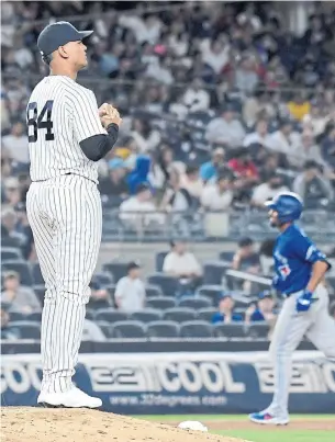  ?? BILL KOSTROUN THE ASSOCIATED PRESS ?? Yankees relief pitcher Albert Abreu waits as the Blue Jays' Marcus Semien runs the bases on a home run in the fifth inning Tuesday, the second baseman’s third straight game with a homer.