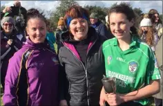  ??  ?? Cloughbawn captain Hannah Keating (right), County Treasurer Angela Gahan (left), and Mary Ogilvie, granddaugh­ter of Edward Kehoe, after whom the cup is named.