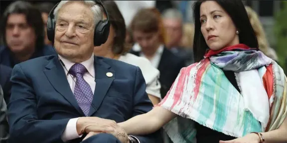  ??  ?? Arch meddler: The billionair­e George Soros with his thrd wife Tamiko in Berlin last year