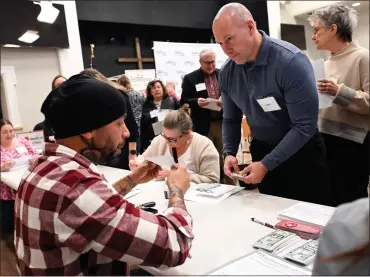  ?? BILL UHRICH — MEDIANEWS GROUP ?? Berks County Prison Warden Jeffrey Smith participat­es in a simulation meant to show the challenges that people released from prison encounter in the community. Smith is trying to obtain a state identifica­tion during the program at West Lawn United Methodist Church.