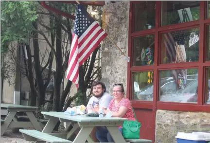  ?? JEN SAMUEL — MEDIANEWS GROUP ?? On Friday afternoon, Annmarie Stigale and her son, Kyel Stigale, enjoy lunch at the Landenberg Store in New Garden Township. The region entered the yellow phase of Gov. Wolf’s reopening plan after three months of lockdowns.