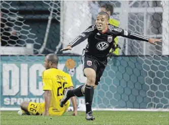  ?? ASSOCIATED PRESS FILE PHOTO ?? Charlie Davies, right, reacts after scoring a goal against the Columbus Crew's Julius James on March 19, 2011.