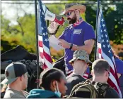  ??  ?? Eric
Schessl, coordinato­r for the Irreverent Warriors Silkies Hike, speaks to the veterans and active military service members who gathered Saturday.