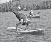  ?? ?? Braeson Schacher does a handstand on a paddle board. The 25-yearold found a passion for adaptive recreation following the loss of his legs in 2014.