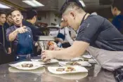  ??  ?? Chef Josh Boutwood and team prepare dishes for the dinner.