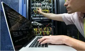  ??  ?? Inside the cloud … a technician checks a server in a data centre. Photograph: Juice Images /Alamy Stock Photo/Alamy Stock Photo