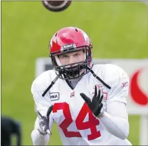  ??  ?? Defensive back Keenan MacDougall warms up before the Calgary Stampeders annual mock game at McMahon Stadium on Sunday.