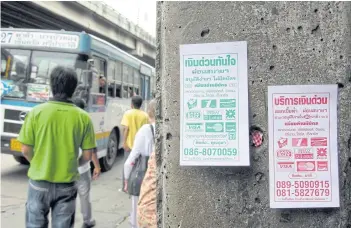  ?? PHRAKRIT JUNTAWONG ?? Leaflets advertisin­g quick loans can be found all over Bangkok.